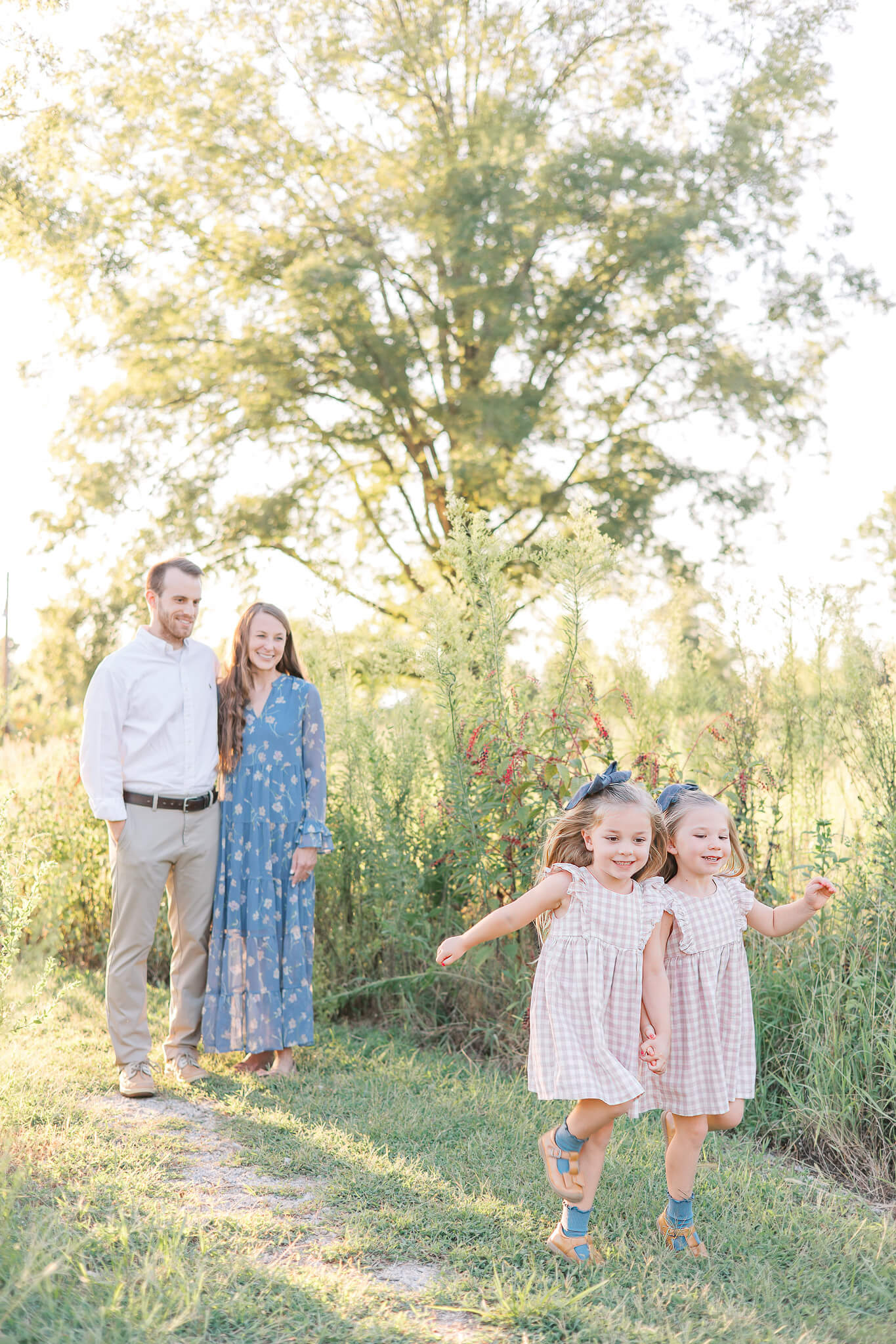 Augusta GA Family Photography - Parents smile while watching their daughters skip and play