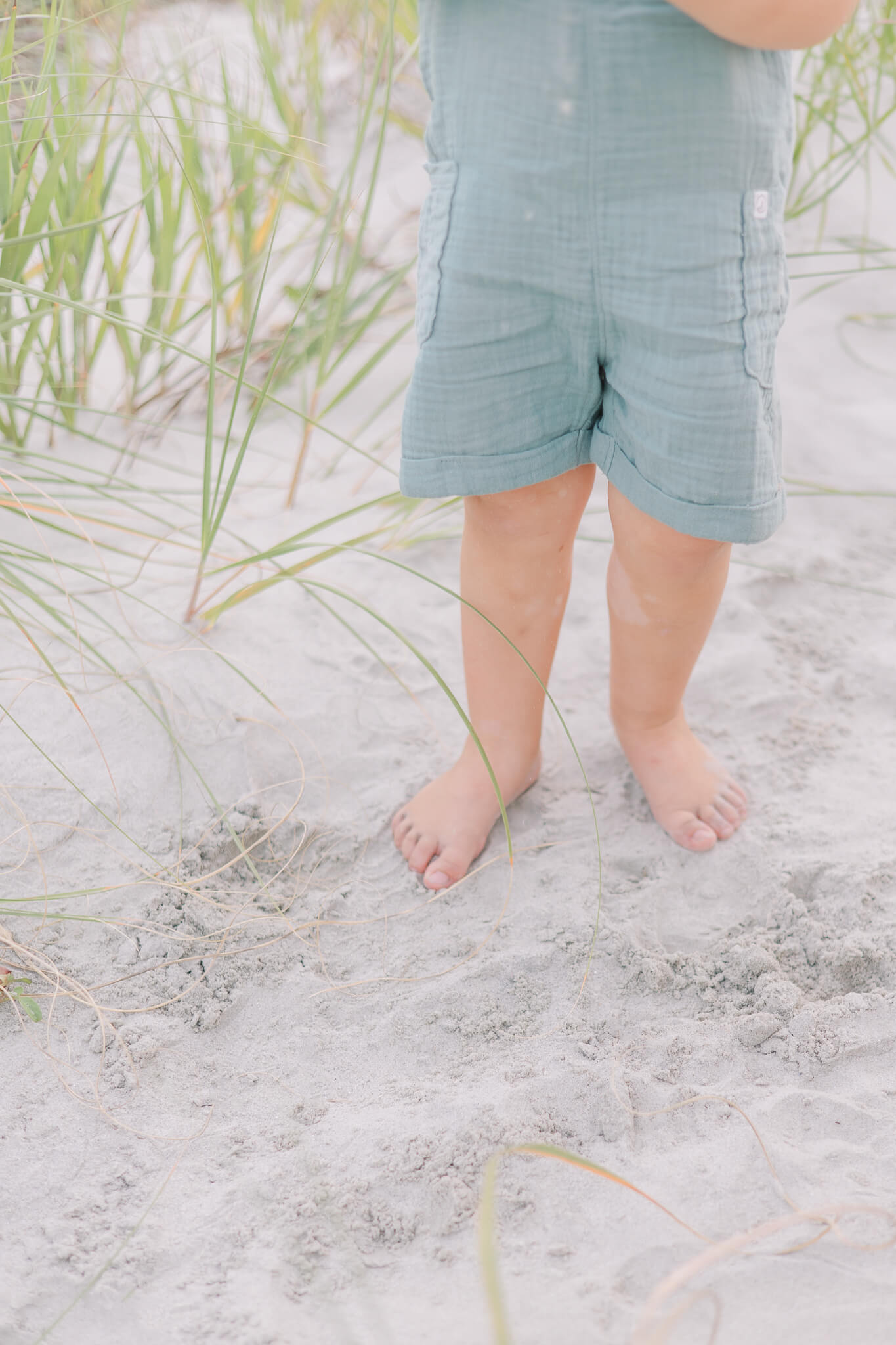 Evans GA Family Photographer - Feet of a young child stand in the sand