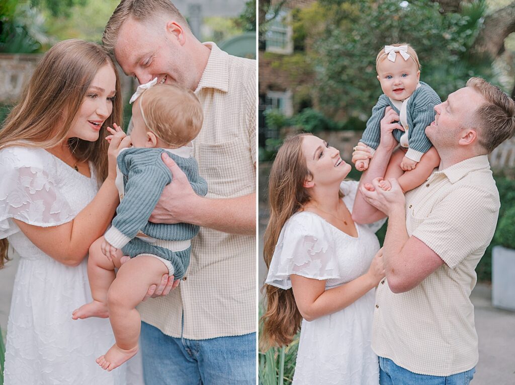 Augusta Photographer - Mom reaches in to kiss her baby's hand. Mom and dad smile looking up at their baby girl on dad's shoulders.