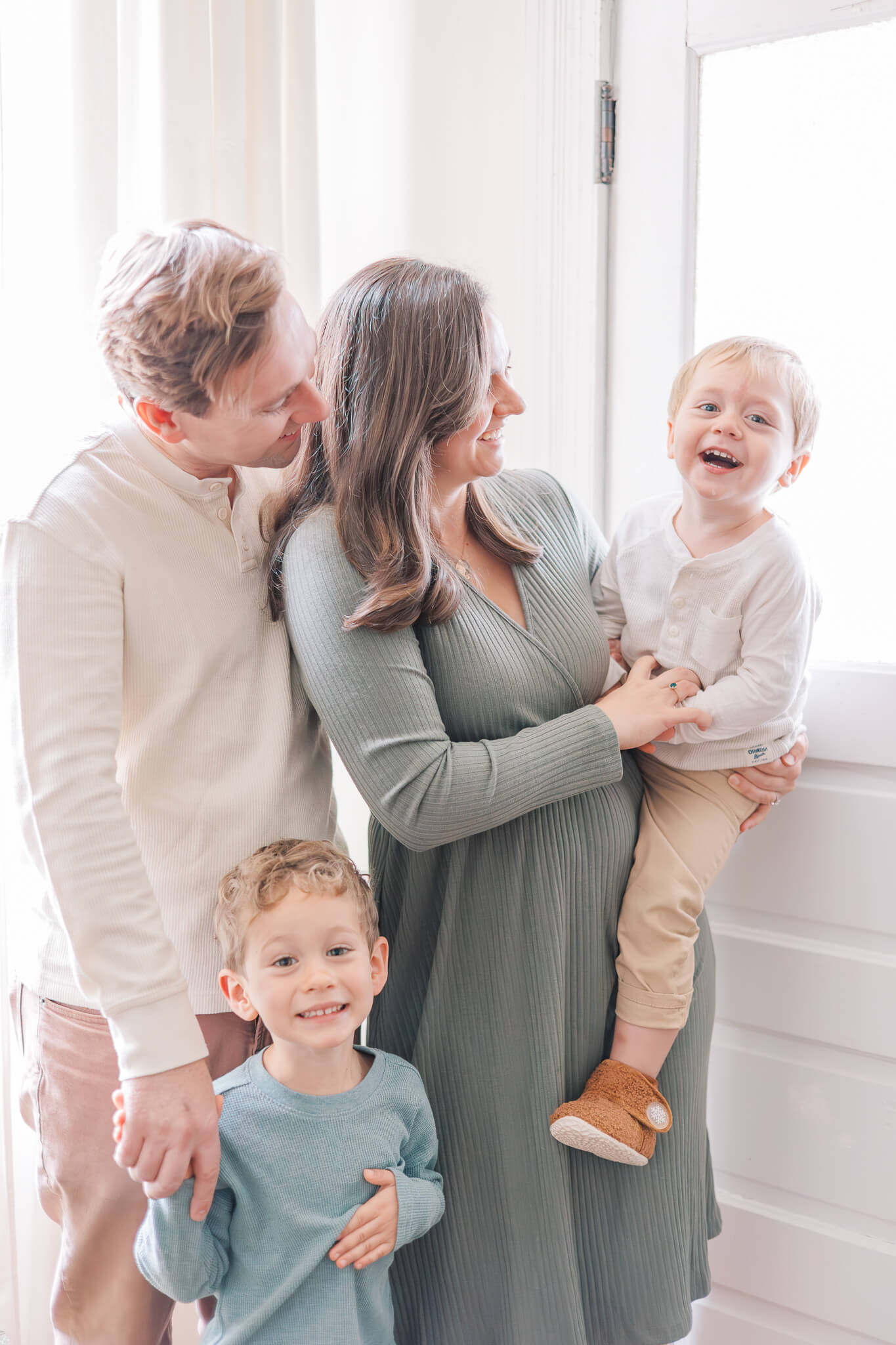 Aiken Photographer - Family stands close together laughing